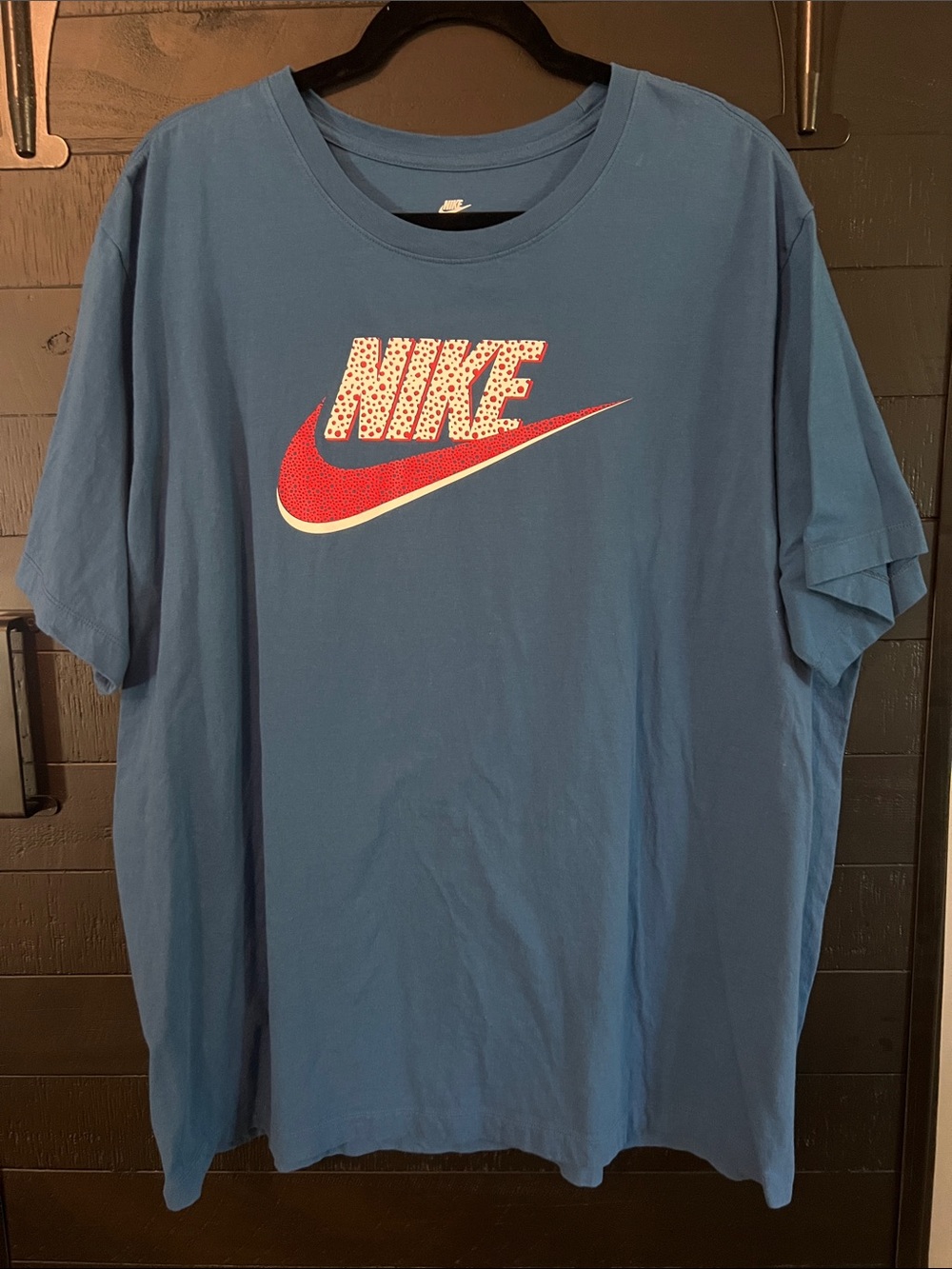 Nike Blue Short Sleeve Tee with Red Swoosh and Patterned Logo